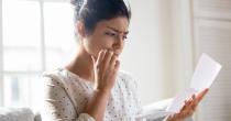 A woman looks at a piece of paper.