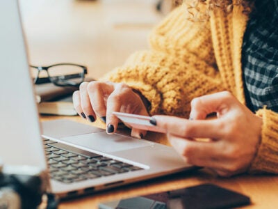 woman using laptop to enter credit card