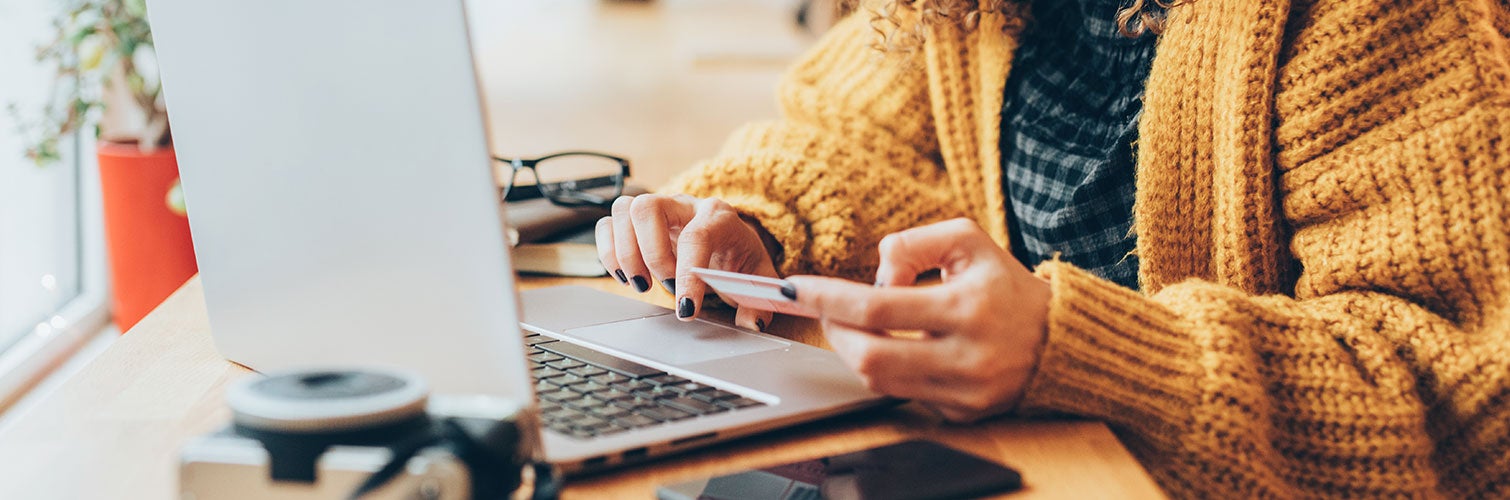 woman using laptop to enter credit card