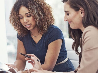 two women looking over paperwork