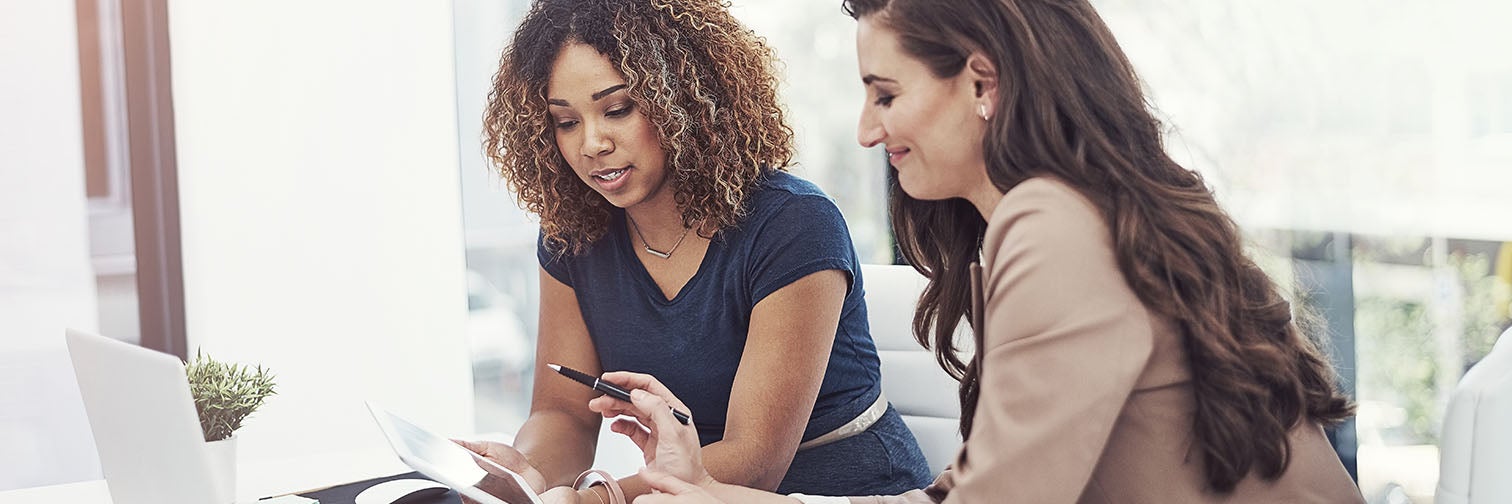 two women looking over paperwork