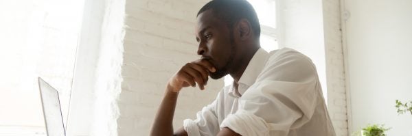 young man contemplating what to do now that credit has been repaired