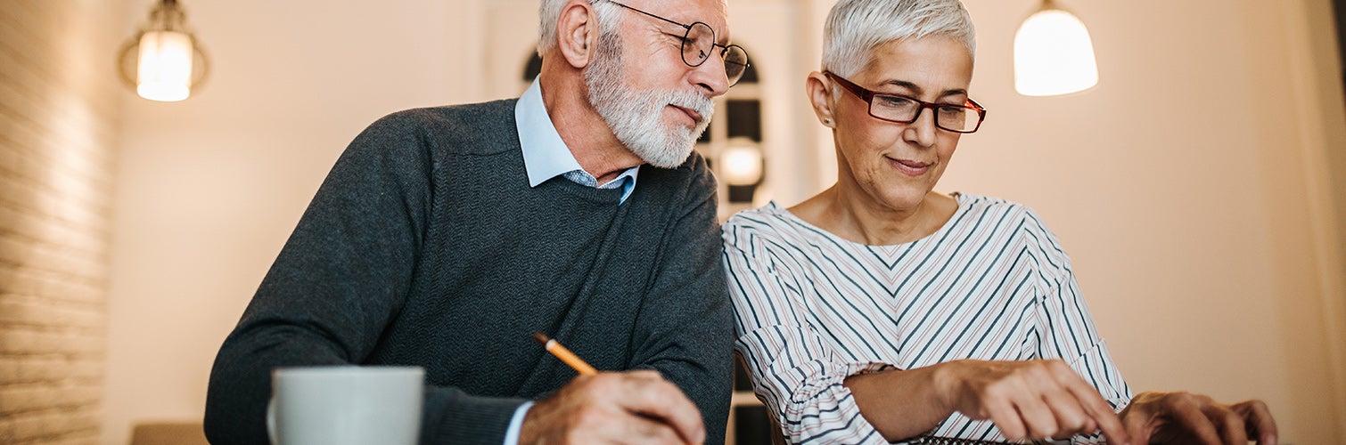 baby boomer couple working on taxes