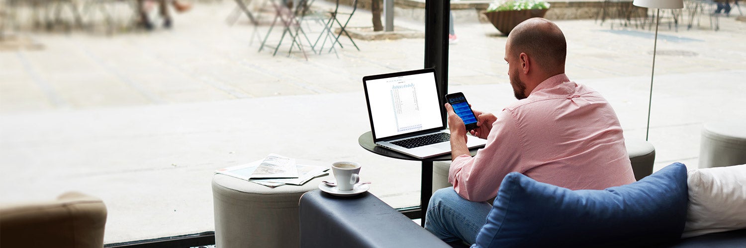 man working on credit application in coffee shop