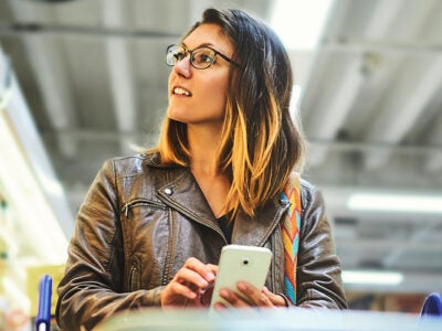 gen z girl shopping in grocery store with smartphone