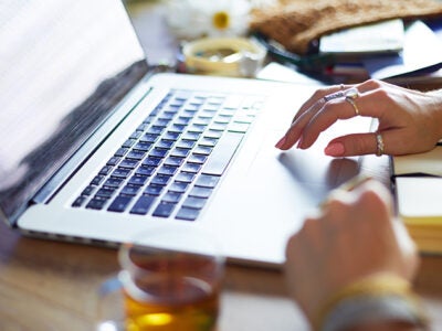 A woman typing on a keyboard