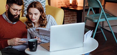 couple sitting on floor working on their finances