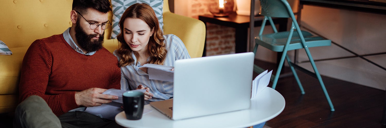 couple sitting on floor working on their finances