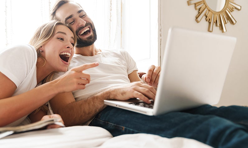 una pareja mirando información en una computadora portátil