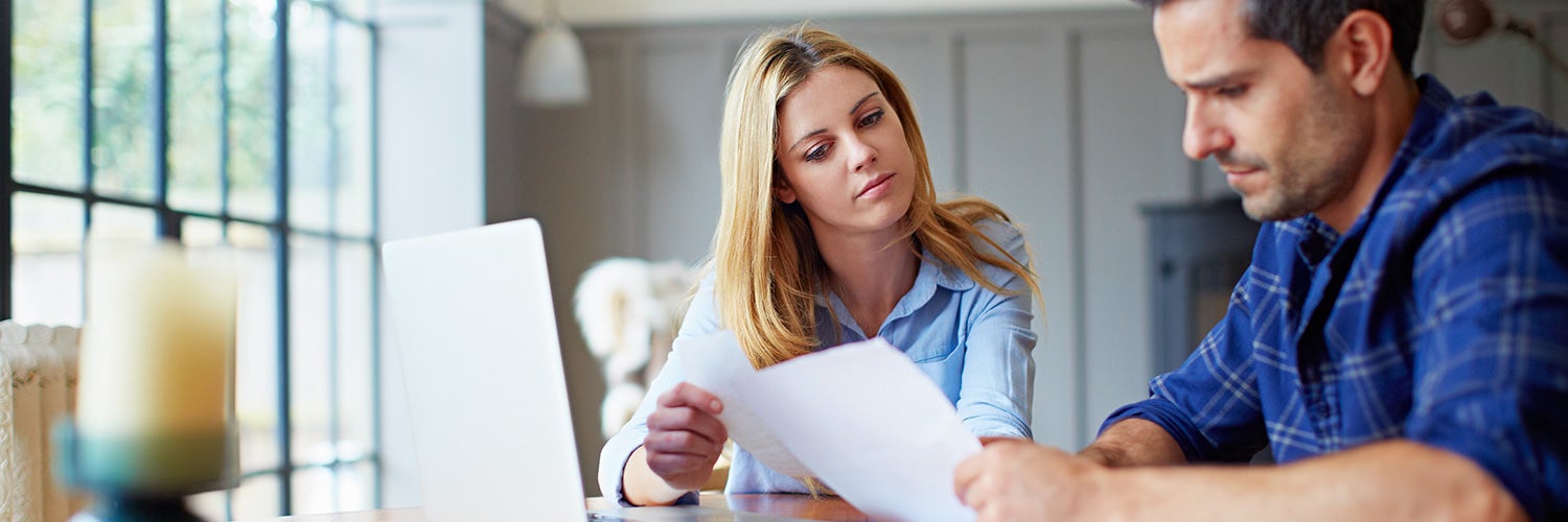 couple looking at paperwork in dining room