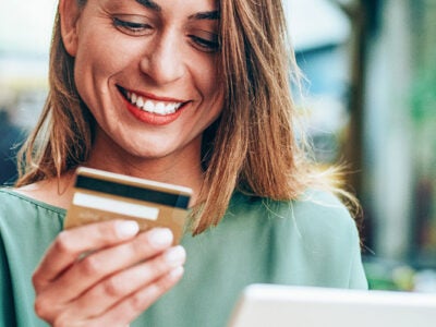 A woman looks at her credit card.