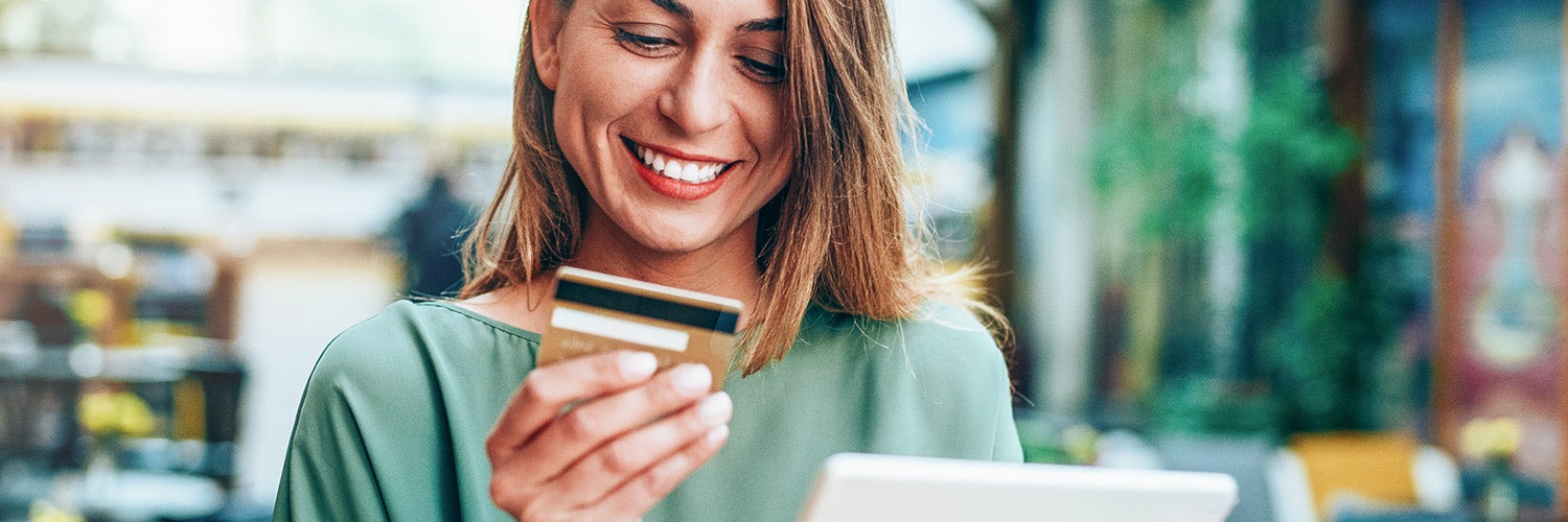 A woman looks at her credit card.