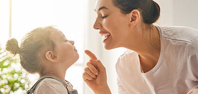 A mother and her daughter play together.