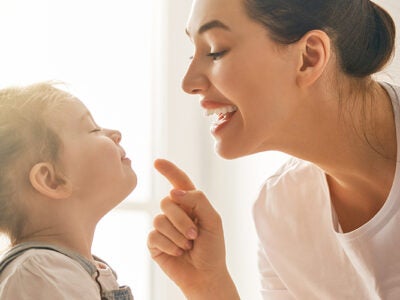 A mother and her daughter play together.