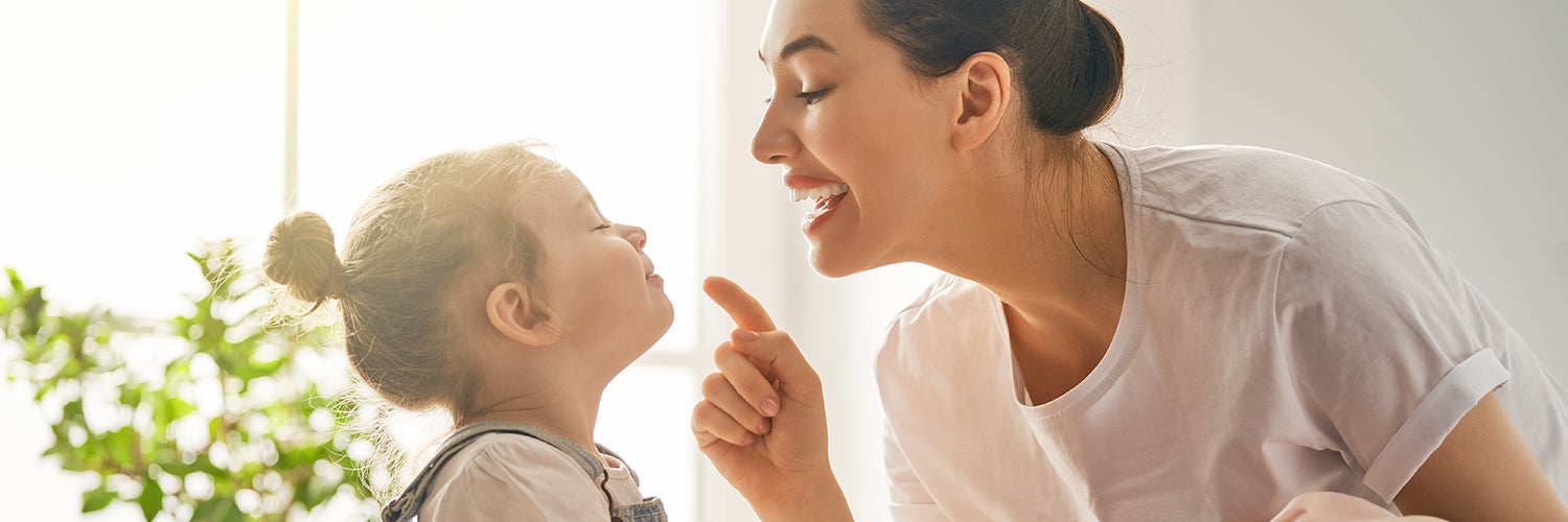 A mother and her daughter play together.