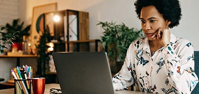 Woman looking at laptop.
