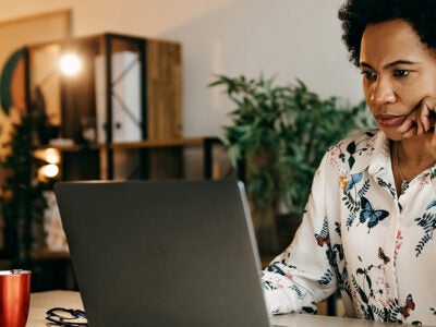 Woman looking at laptop.