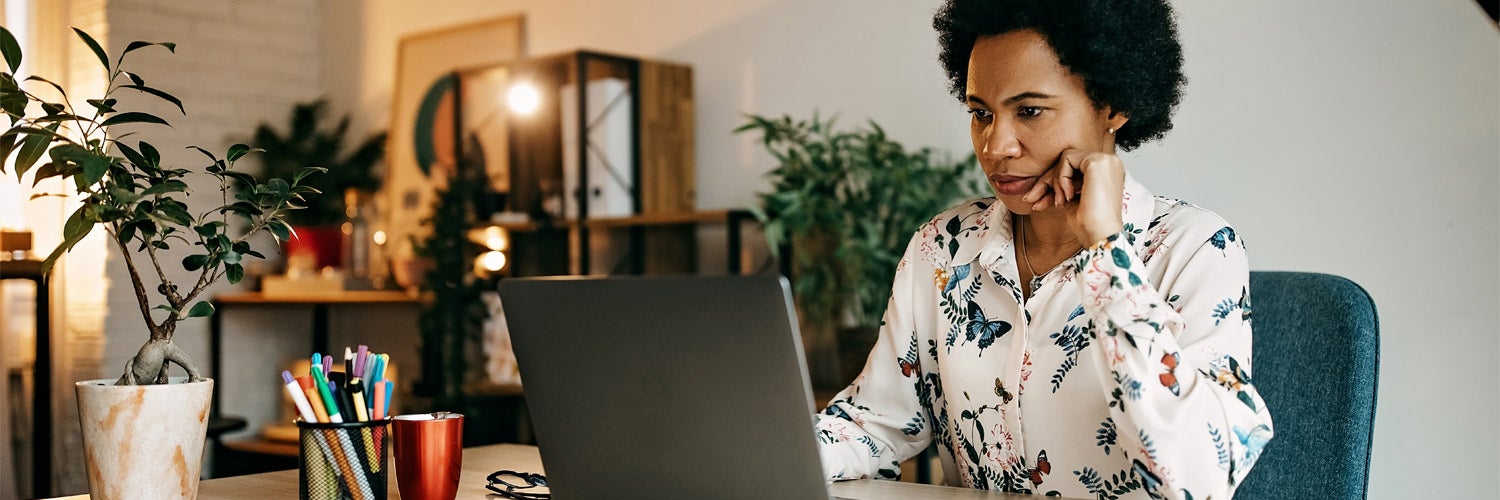 Woman looking at laptop.