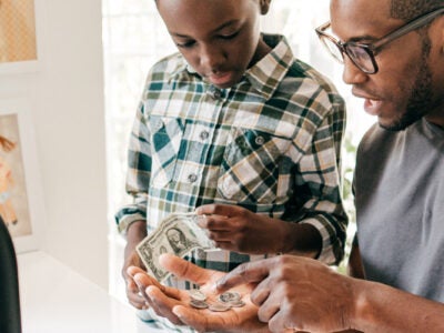 Father teaching son about finances.