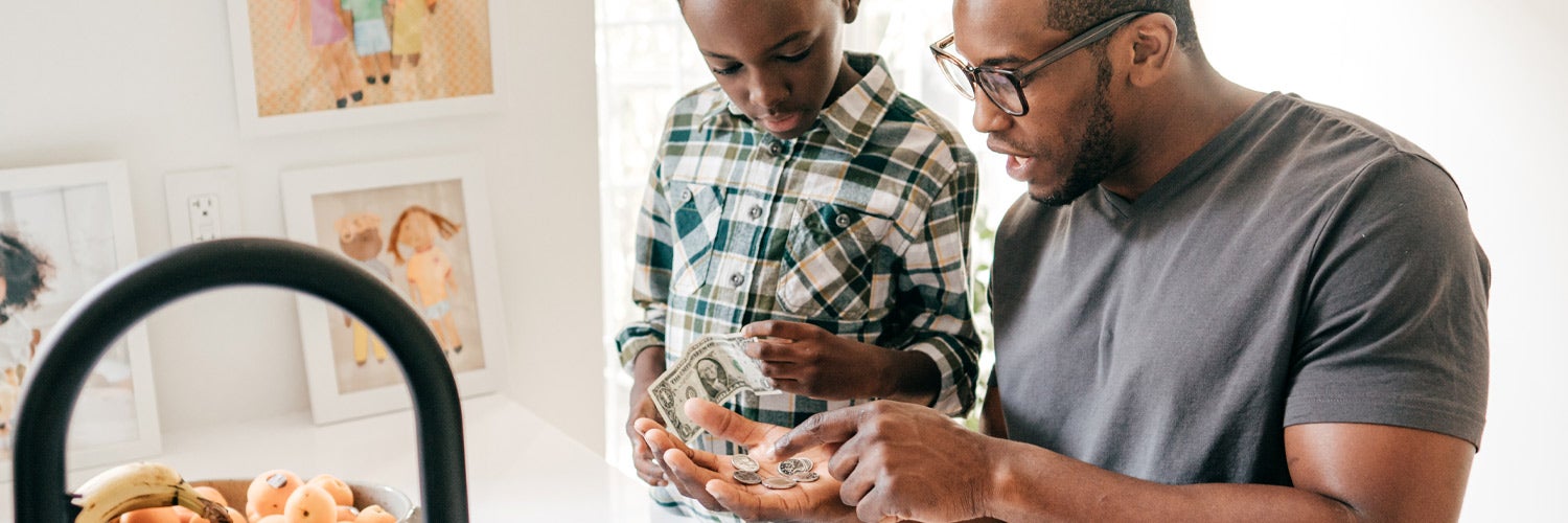 Father teaching son about finances.