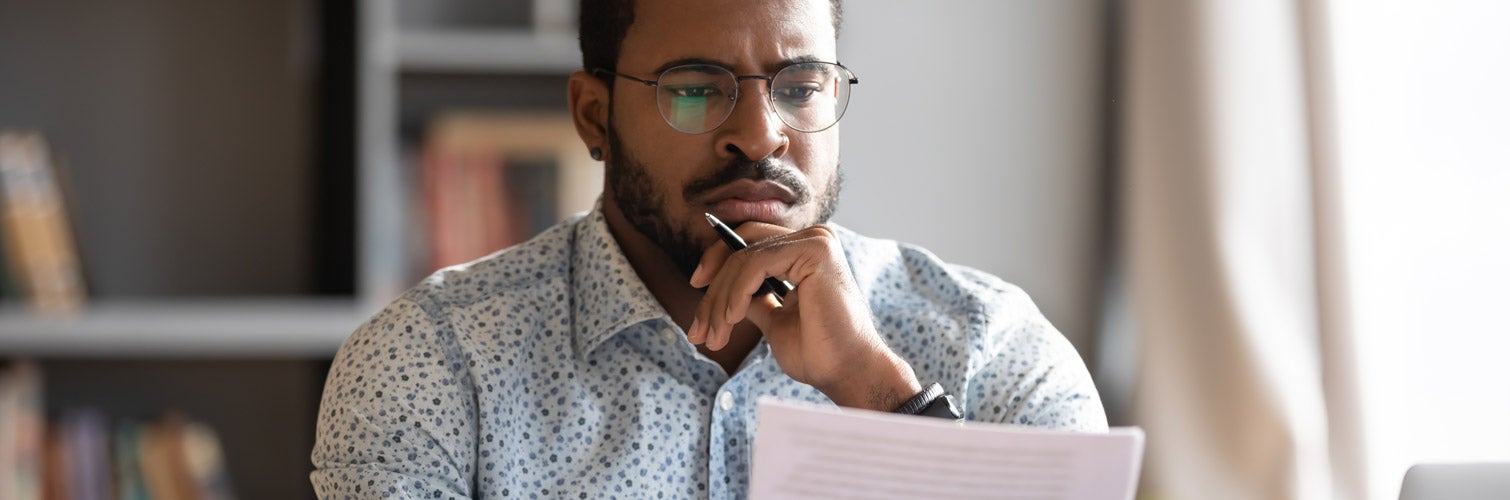 Man reviewing debt on his computer.