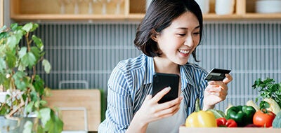 Woman looking at credit card.