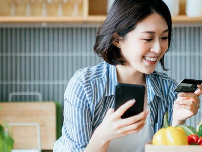 Woman looking at credit card.