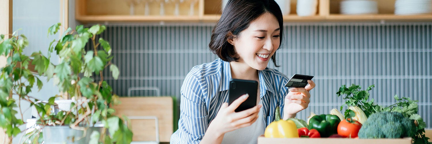 Woman looking at credit card.