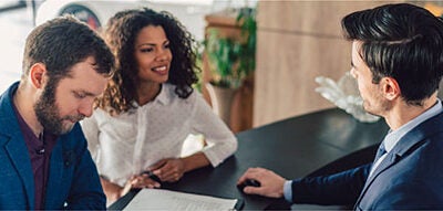 Couple discussing auto financing.