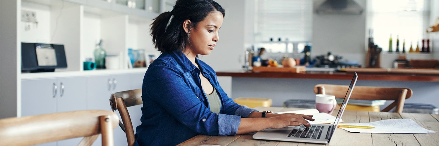 A woman typing on her laptop