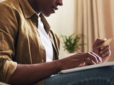 Man using credit card to make online purchase.