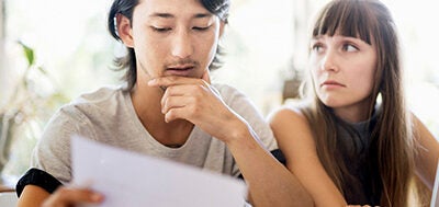 Couple looking over paperwork together.
