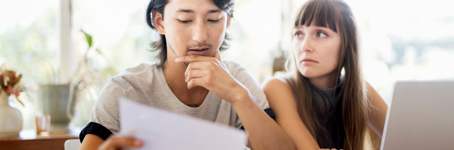 Couple looking over paperwork together.