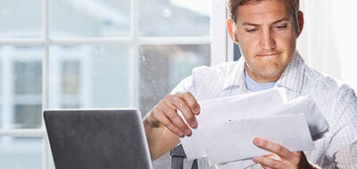 Man looking at bills.