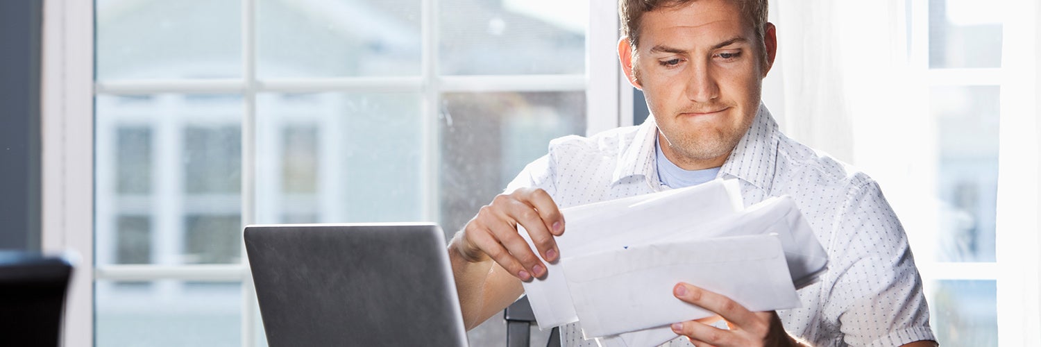 Man looking at bills.