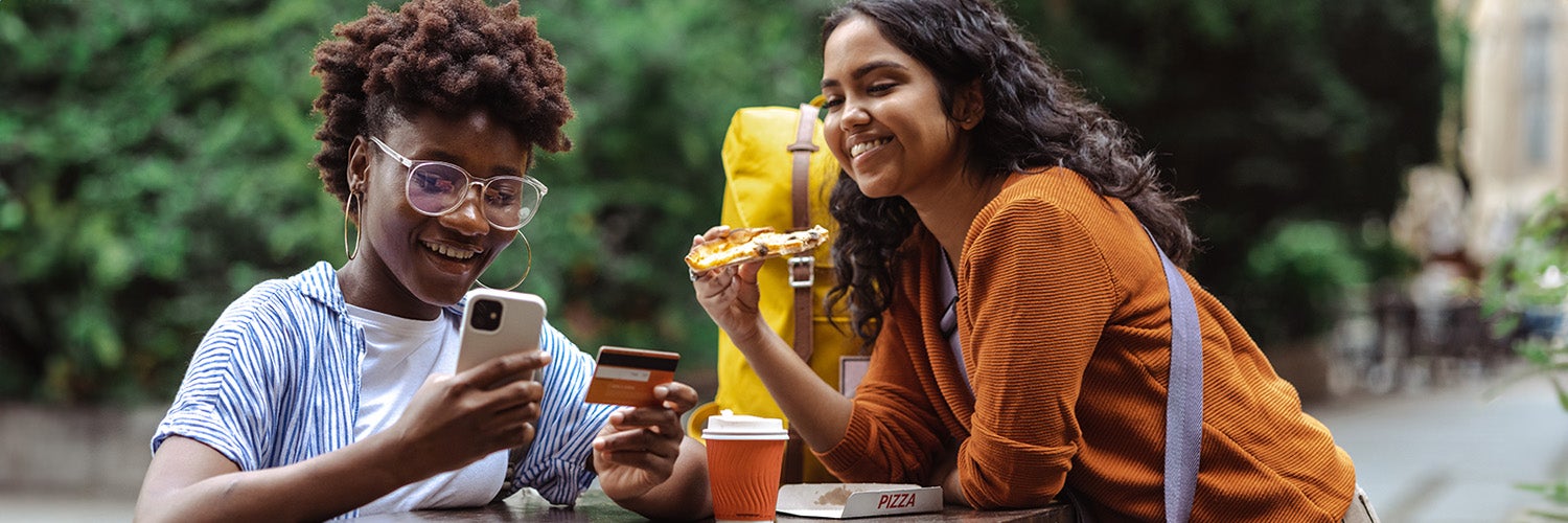 A student out with friends paying for something with a credit card