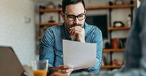 person looks at credit score related documents